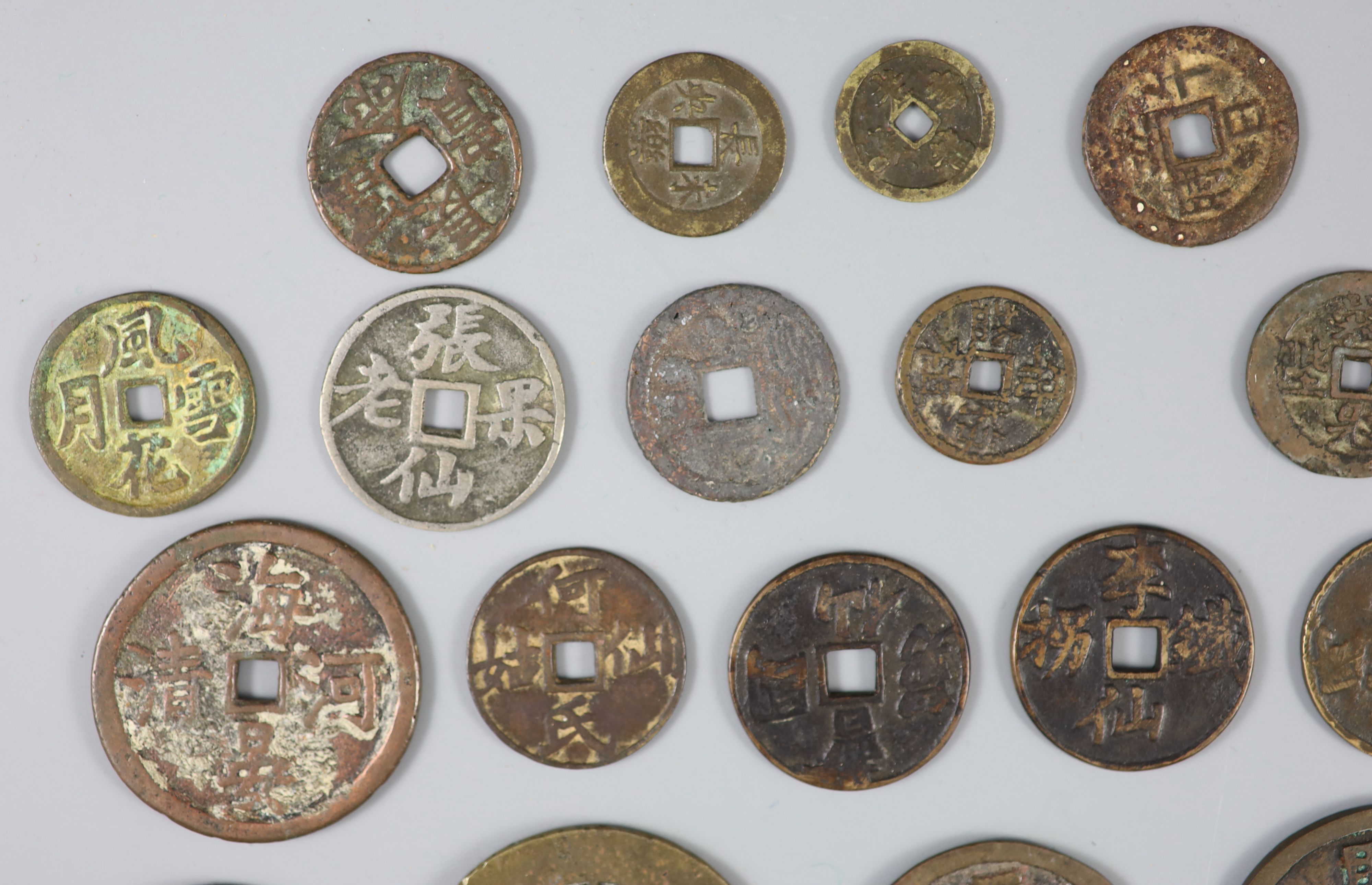 China, a group of 26 bronze or brass charms or amulets, Qing dynasty,